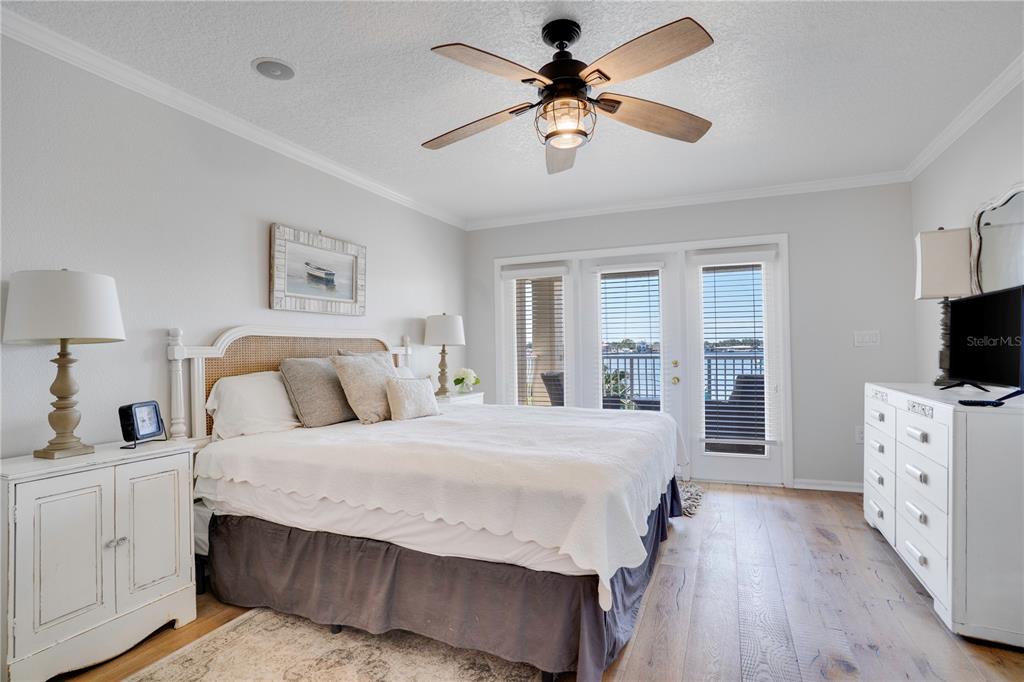 333 12th Avenue Indian Rocks Beach, FL 33785 - Photo 37 of 64 a bedroom with a large bed and a flat tv screen on dresser