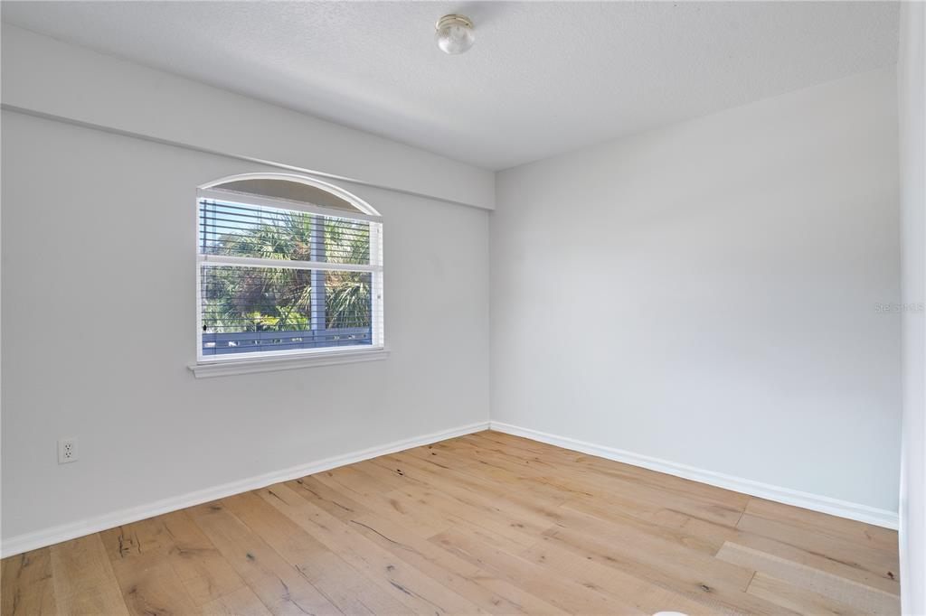 333 12th Avenue Indian Rocks Beach, FL 33785 - Photo 44 of 64 an empty room with wooden floor and windows