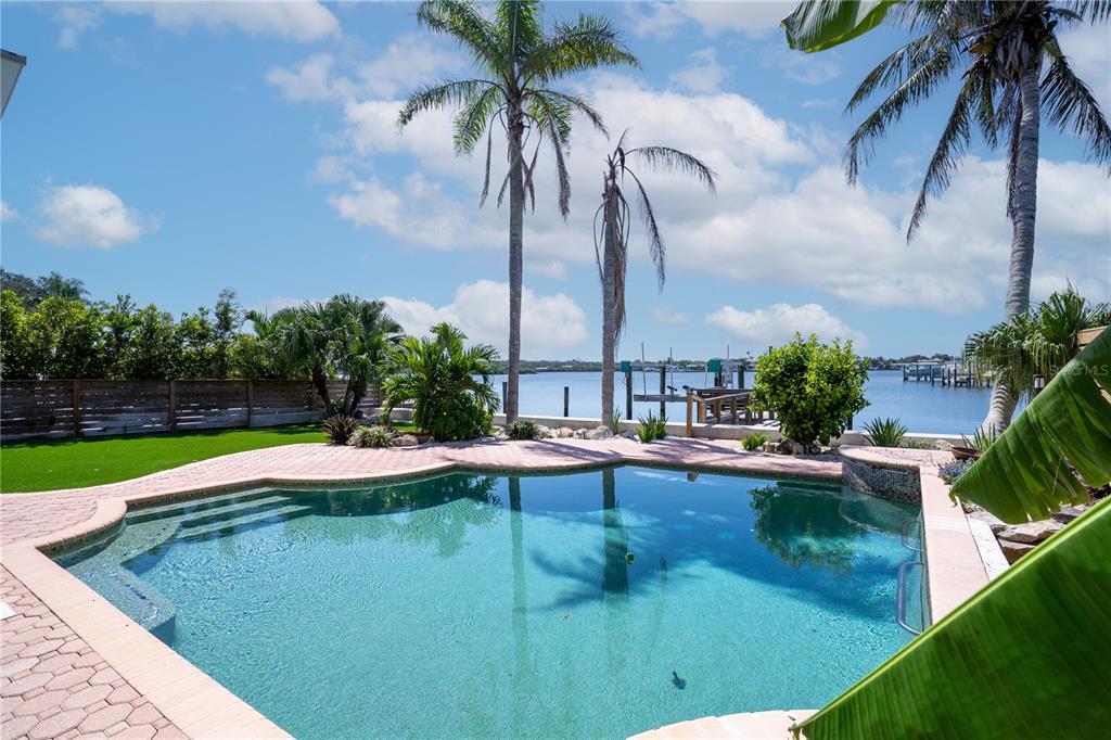 333 12th Avenue Indian Rocks Beach, FL 33785 - Photo 49 of 64 a view of a swimming pool with a table and chairs