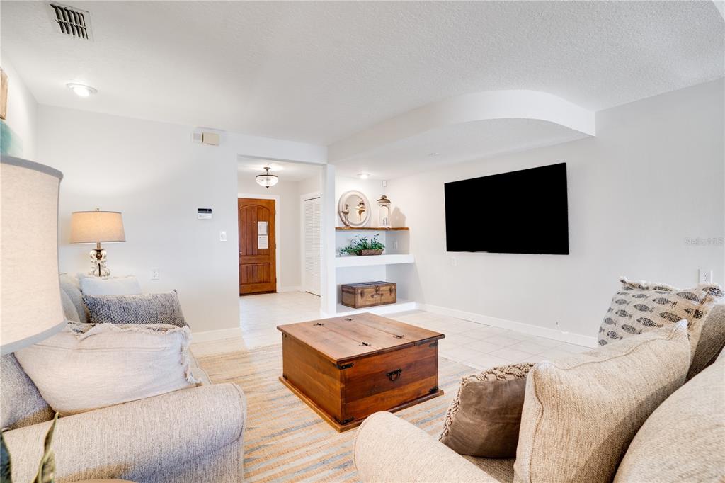 333 12th Avenue Indian Rocks Beach, FL 33785 - Photo 8 of 64 a living room with furniture and a flat screen tv