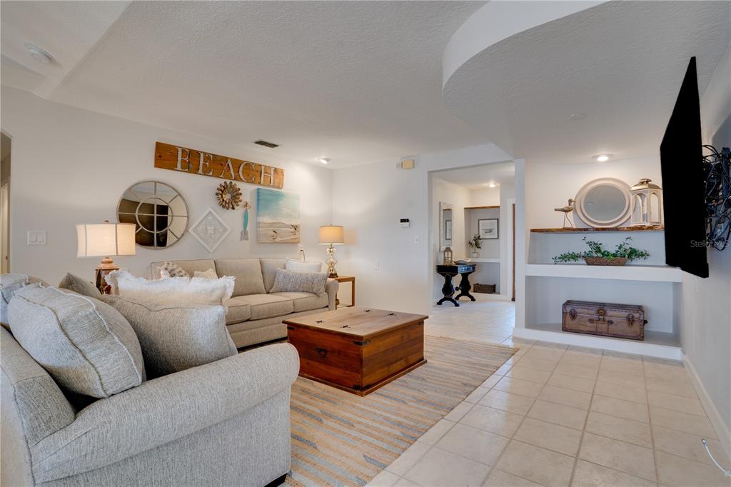 333 12th Avenue Indian Rocks Beach, FL 33785 - Photo 9 of 64 a living room with furniture and a flat screen tv