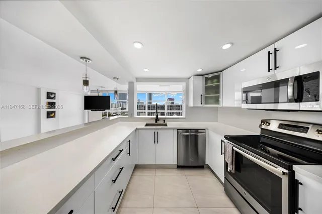 a bathroom with a sink a large mirror and a toilet