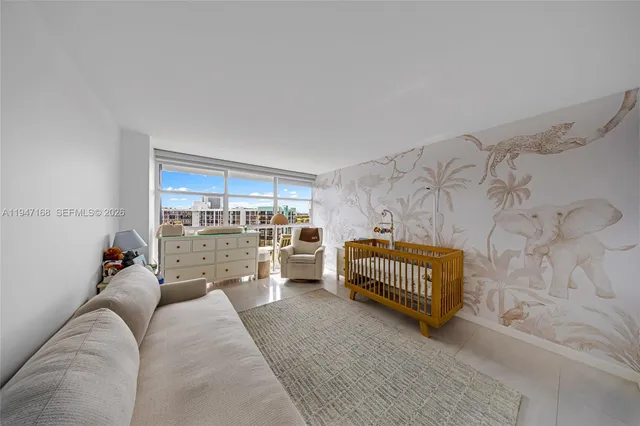a view of a swimming pool with a lawn chairs under palm trees