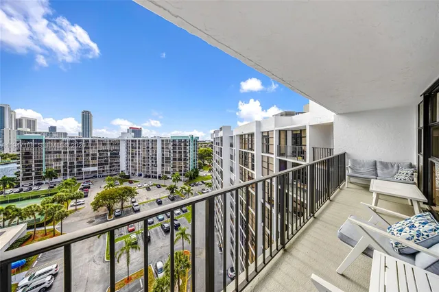 a room with furniture pool table and wooden floor