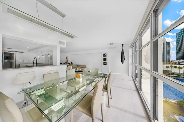 a view of a dining room with furniture and a kitchen