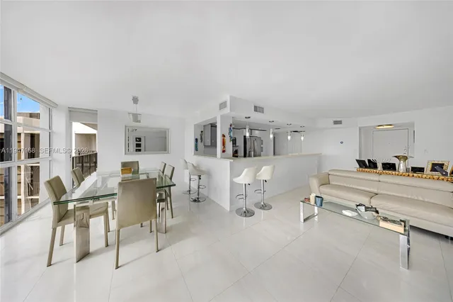 a large kitchen with stainless steel appliances and white cabinets