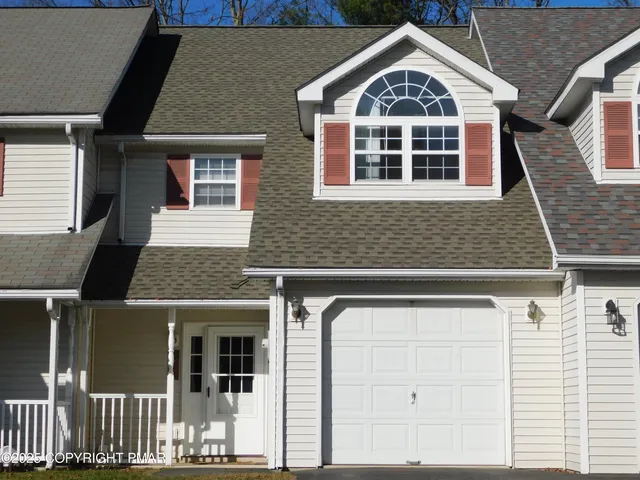 a view of a brick house with large windows