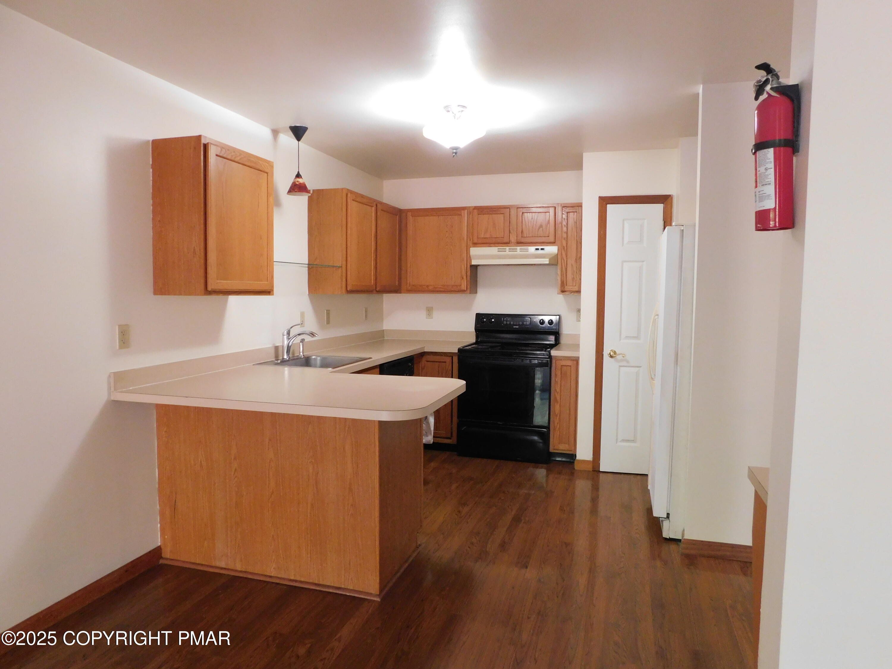 613 Country Acres Court Effort, PA 18330 - Photo 3 of 18 a kitchen with stainless steel appliances granite countertop a refrigerator a sink dishwasher and a stove with wooden floor