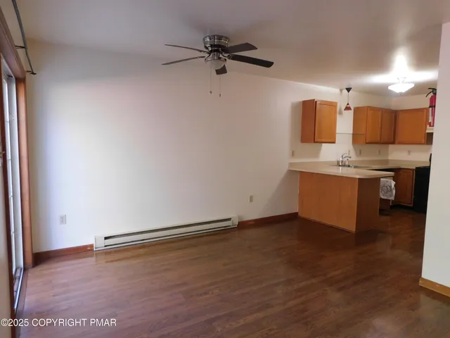 a view of a kitchen with a sink and a refrigerator