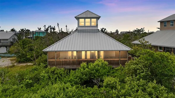an aerial view of a house next to a yard