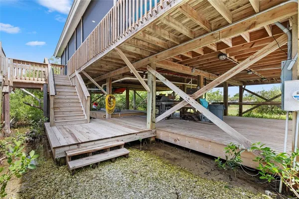 a patio with lawn chairs and wooden floor