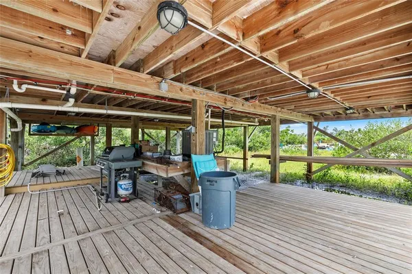 a view of a patio with a table chairs and wooden floor