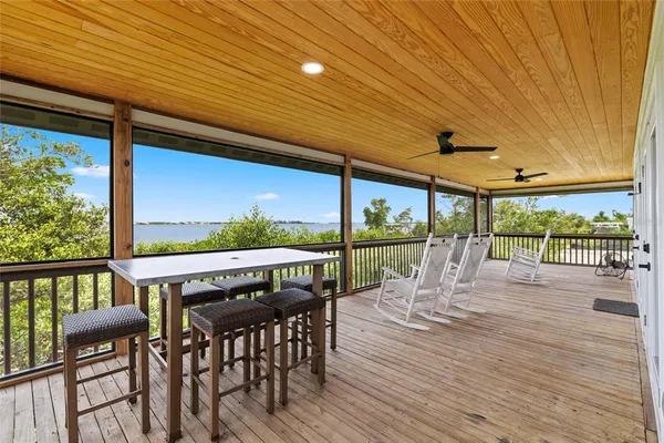 a view of a chairs and table in patio with a swimming pool
