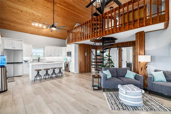 a kitchen with a dining table chairs and white cabinets