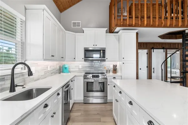 a view of a kitchen with living room and furniture