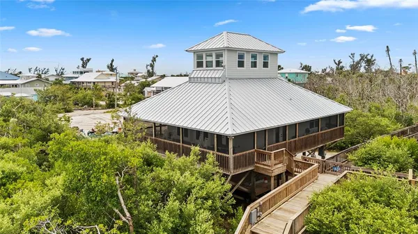 a view of a house with roof deck and sitting area