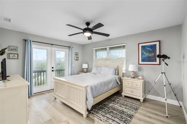 a bedroom with two beds and a chandelier