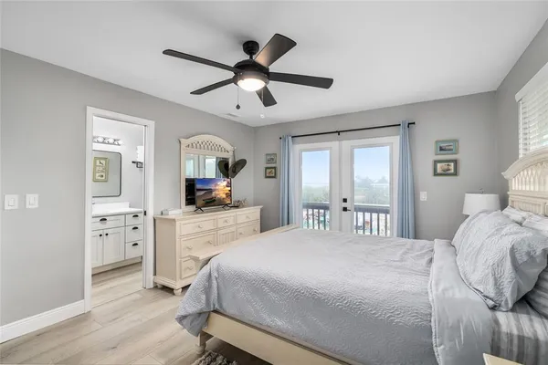 a bedroom with furniture and a wooden floor