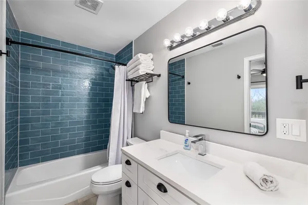 a view of a hallway with a livingroom and a livingroom with furniture