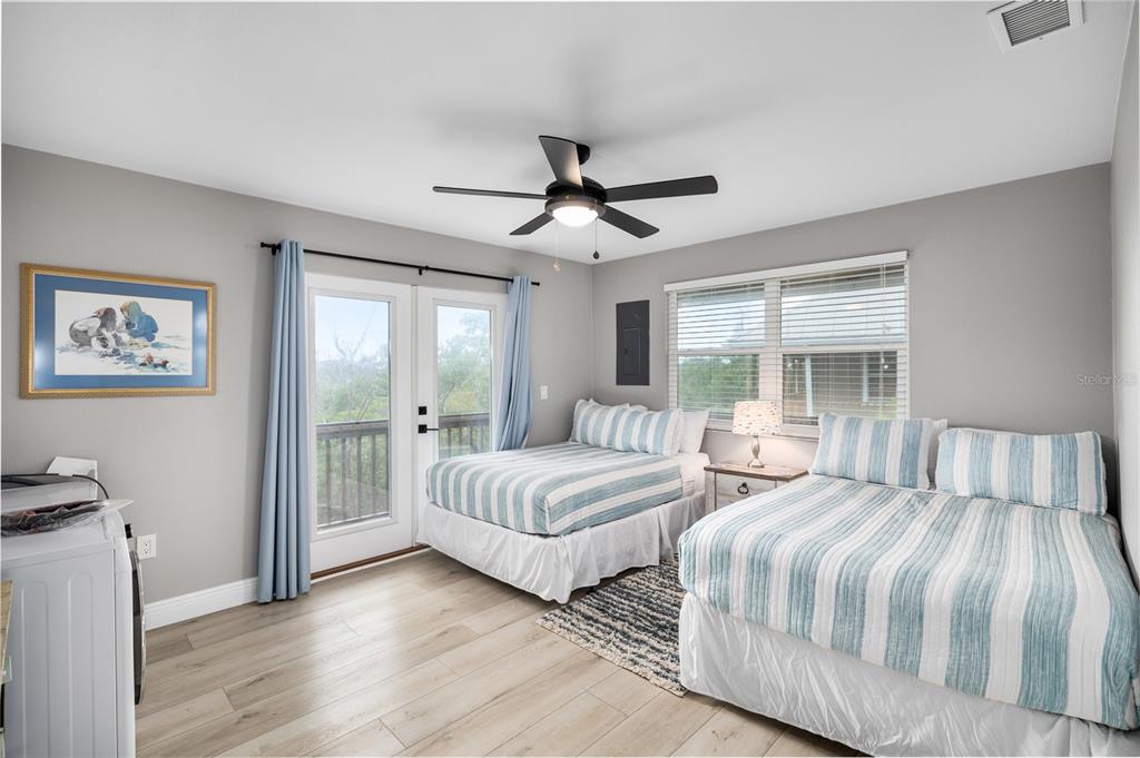 8772 Little Gasparilla Placida, FL 33946 - Photo 34 of 54 a bedroom with two beds and a chandelier