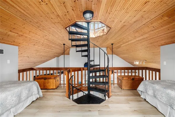 a spacious bedroom with a bed and a window