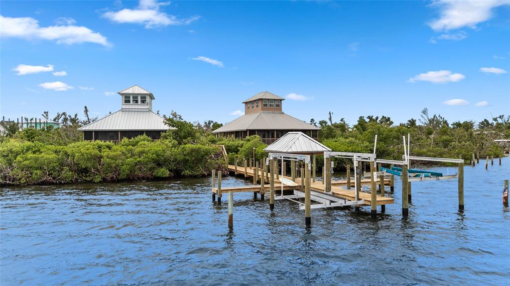 8772 Little Gasparilla Placida, FL 33946 - Photo 5 of 54 a view of a house with wooden deck and furniture