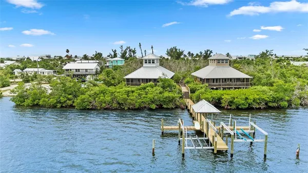 a view of a chairs and table under an umbrella in patio