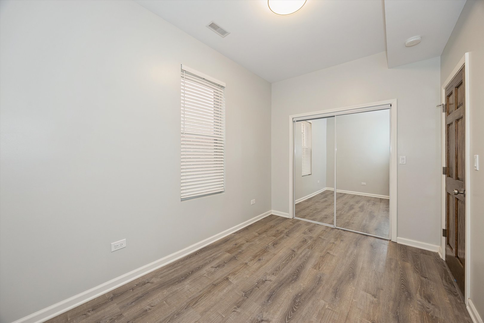 2008 West Addison Street, Unit 2 Chicago, IL 60618 - Photo 9 of 19 an empty room with wooden floor and windows