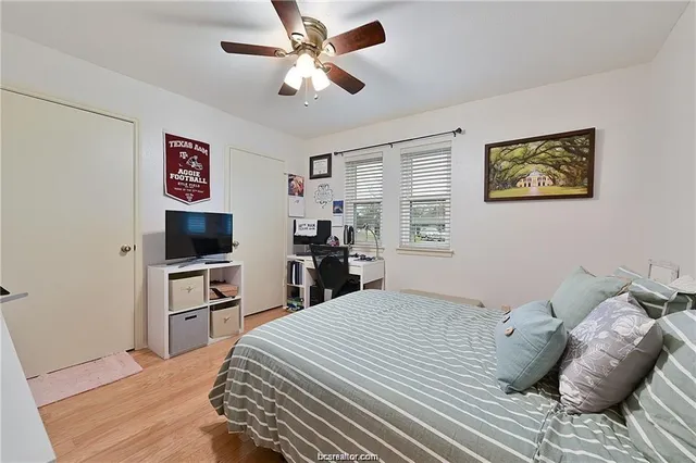 a bedroom with a bed and a flat screen tv