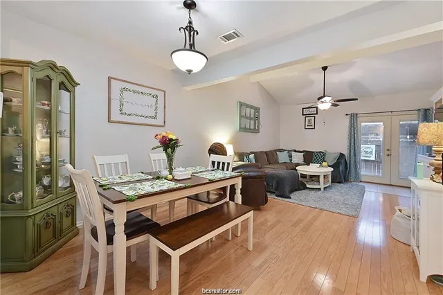 a living room with furniture dining table and wooden floor