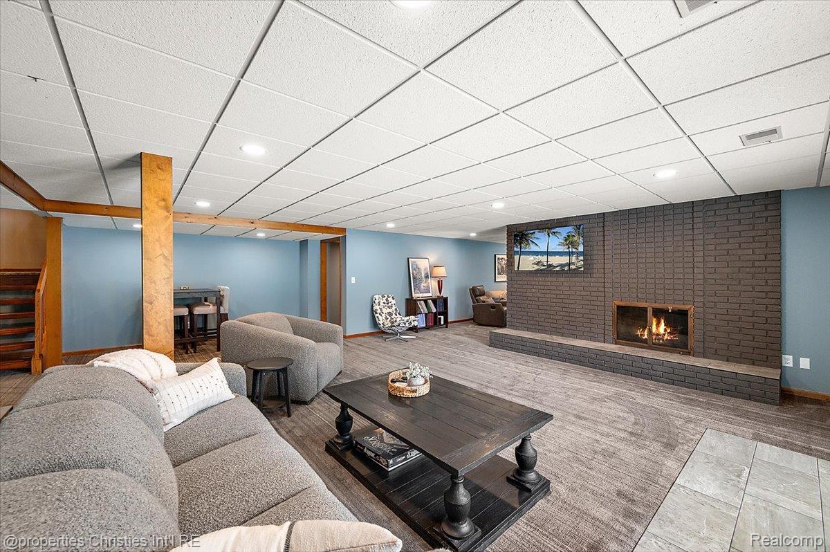 1071 Woodbridge Lane Rochester, MI 48306 - Photo 53 of 76 Living area featuring a brick fireplace, a drop ceiling, and recessed lighting