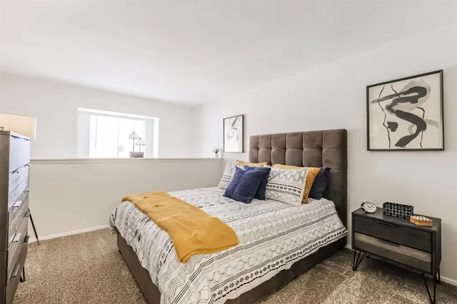 a bedroom with a bed and a couch