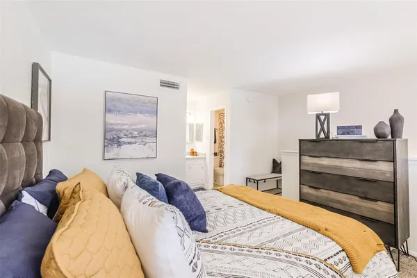 a bedroom with a bed and lamp