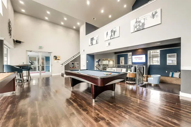 a living room with furniture a table and kitchen view