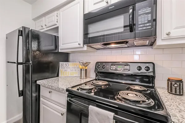 a stove top oven sitting inside of a kitchen
