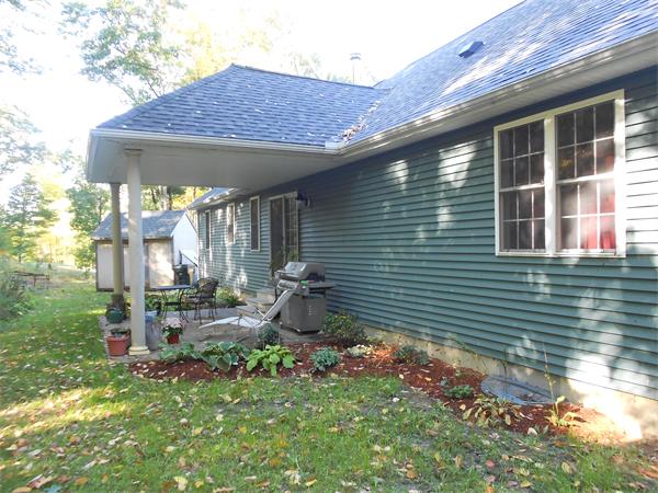 8 Collins Road North Brookfield, MA 01535 - Photo 23 of 27 a backyard of a house with outdoor seating