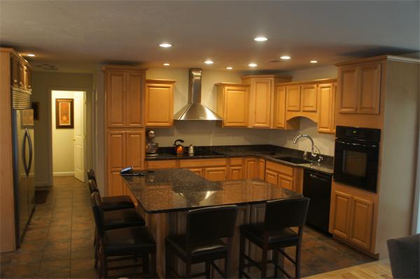 8 Collins Road North Brookfield, MA 01535 - Photo 3 of 27 a kitchen with stainless steel appliances granite countertop a stove a sink a refrigerator white cabinets and wooden floor