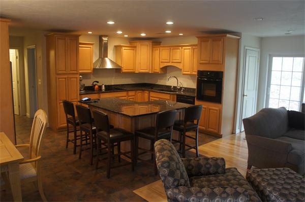 8 Collins Road North Brookfield, MA 01535 - Photo 6 of 27 a kitchen with stainless steel appliances kitchen island granite countertop a table and chairs