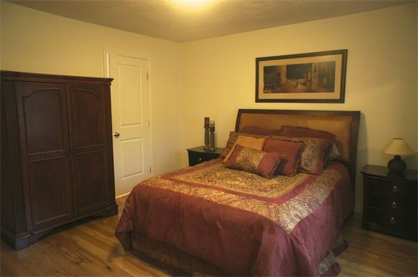8 Collins Road North Brookfield, MA 01535 - Photo 10 of 27 a bed sitting in a bedroom next to a wooden door