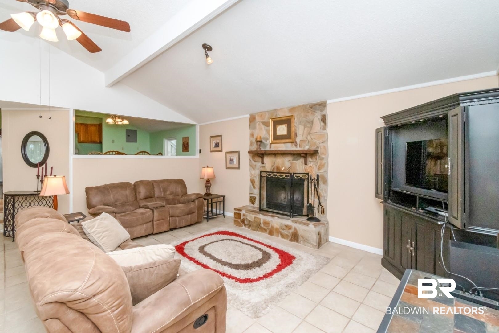 1321 Rainbow Drive West Mobile, AL 36693 - Photo 16 of 48 Tiled living room featuring vaulted ceiling with beams, a fireplace, and ceiling fan