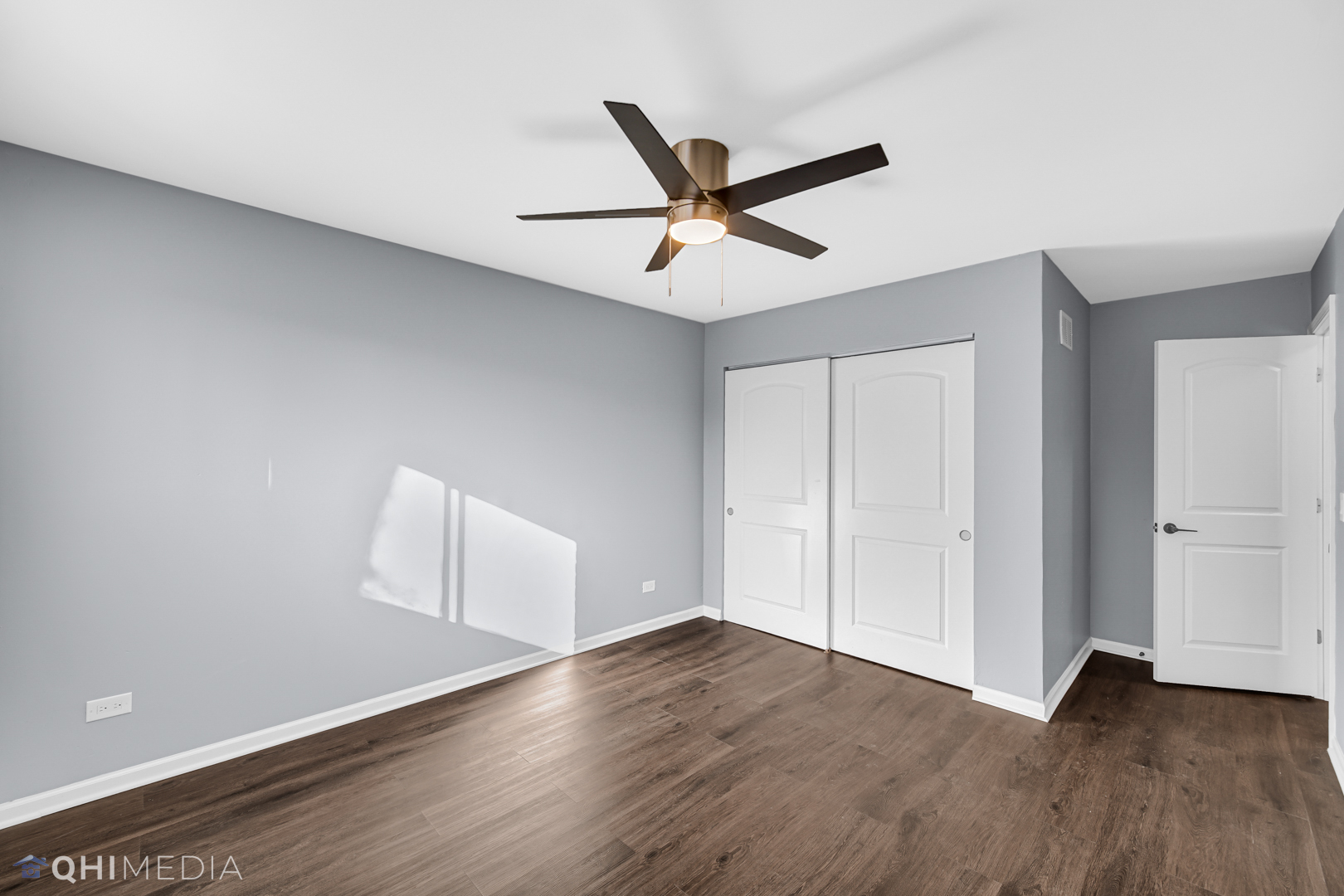 157 Virginia Court Streamwood, IL 60107 - Photo 11 of 17 an empty room with wooden floor and windows