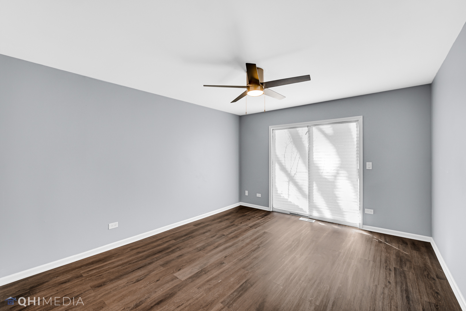 157 Virginia Court Streamwood, IL 60107 - Photo 12 of 17 an empty room with wooden floor and windows