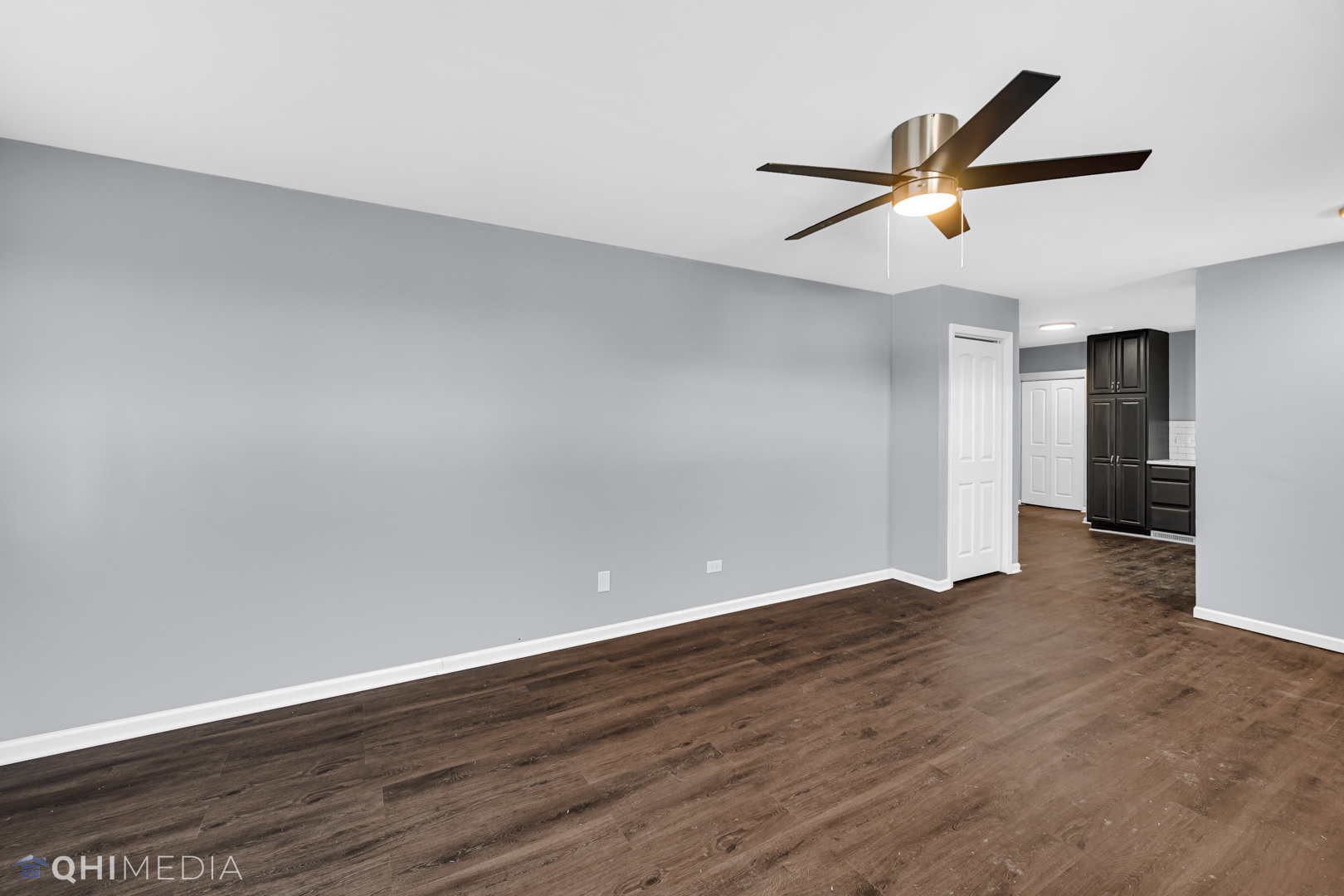 157 Virginia Court Streamwood, IL 60107 - Photo 16 of 17 a view of an empty room with wooden floor and a ceiling fan