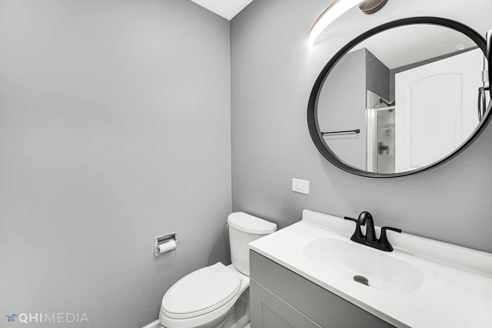 157 Virginia Court Streamwood, IL 60107 - Photo 4 of 17 a bathroom with a sink a toilet and a mirror