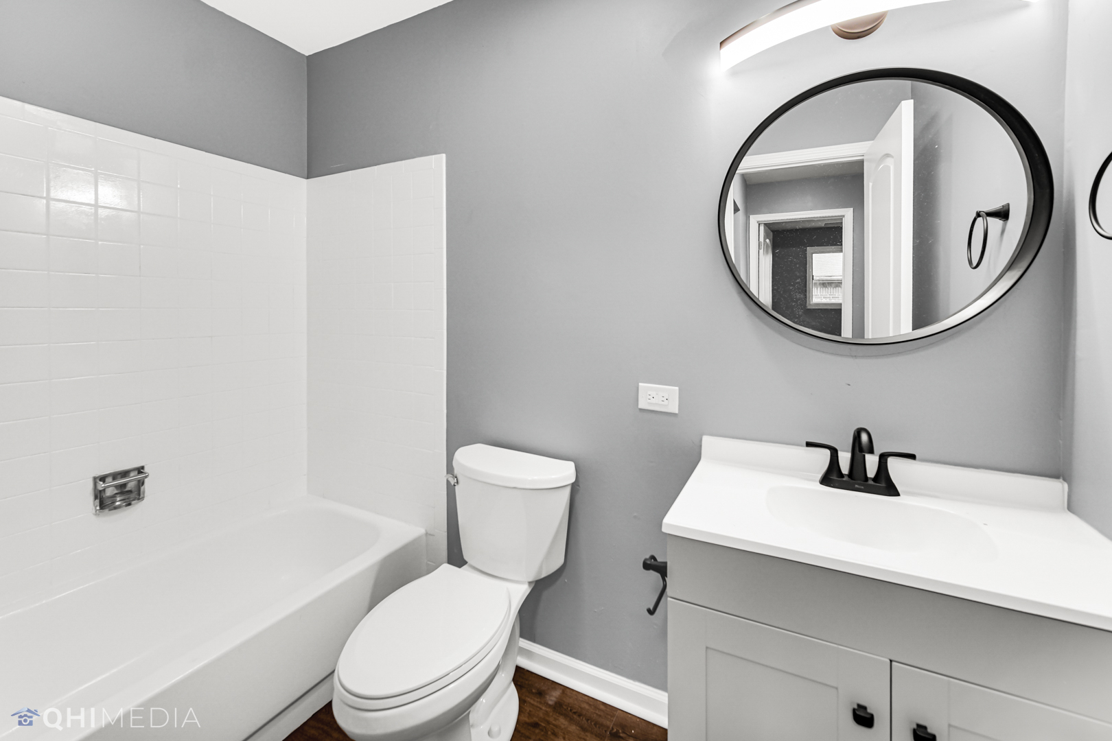 157 Virginia Court Streamwood, IL 60107 - Photo 5 of 17 a bathroom with a toilet a sink and a mirror