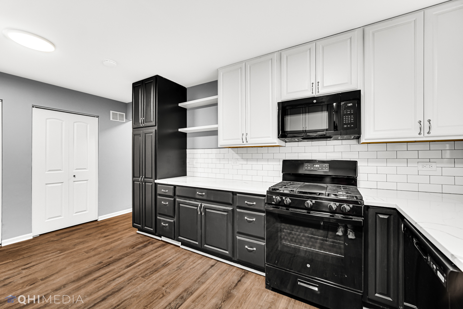 157 Virginia Court Streamwood, IL 60107 - Photo 8 of 17 a kitchen with stainless steel appliances a stove microwave and sink