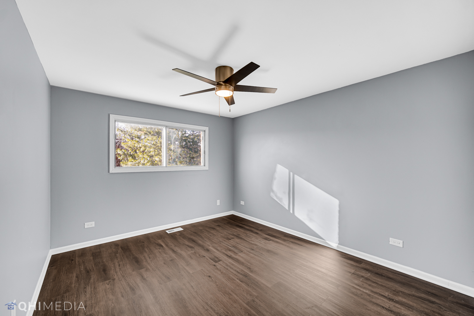 157 Virginia Court Streamwood, IL 60107 - Photo 10 of 17 an empty room with wooden floor and windows