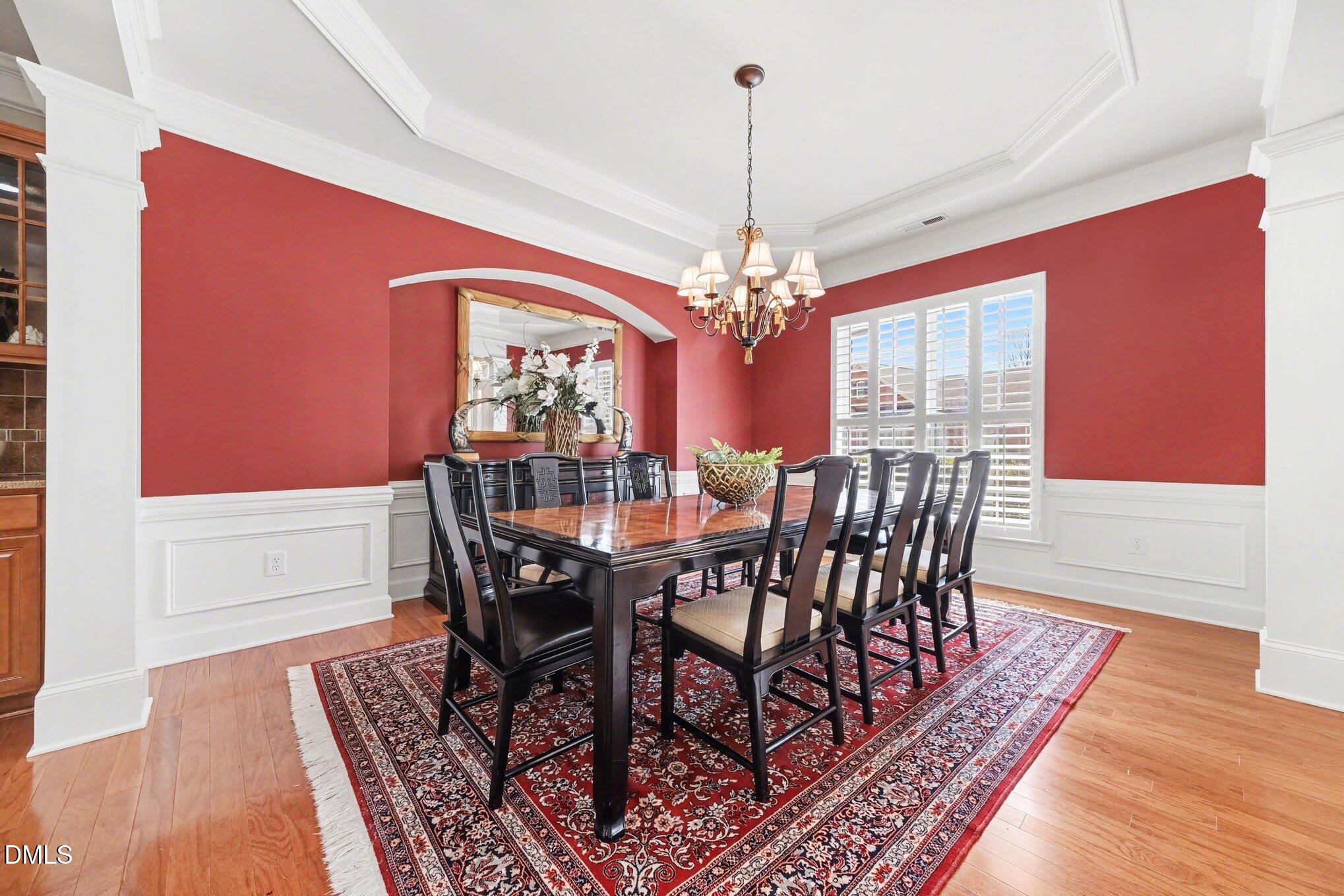 281 Beckingham Loop Cary, NC 27519 - Photo 8 of 56 a view of a dining room with furniture a chandelier and wooden floor