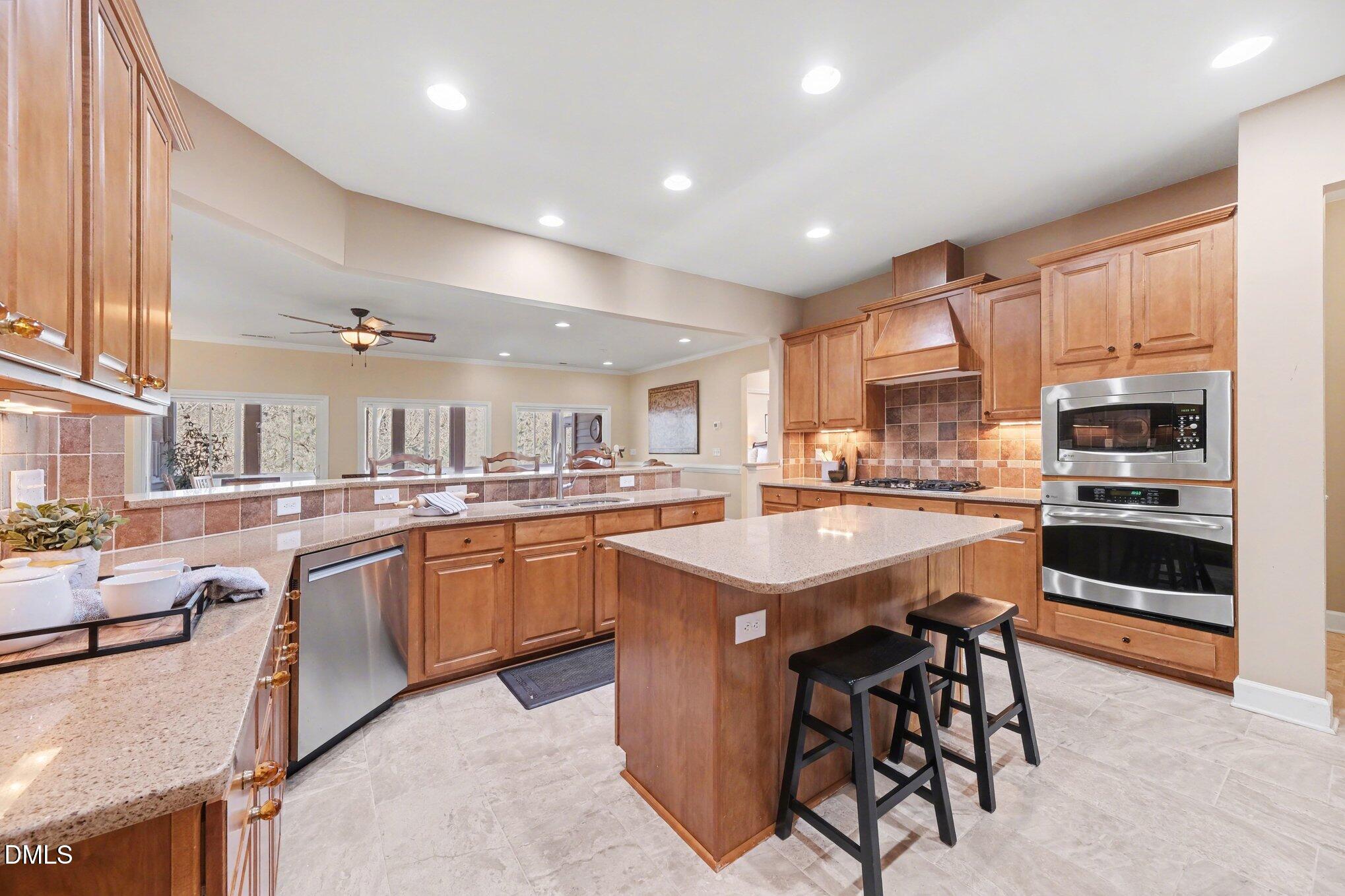 281 Beckingham Loop Cary, NC 27519 - Photo 14 of 56 a kitchen with appliances a sink a counter top space and cabinets