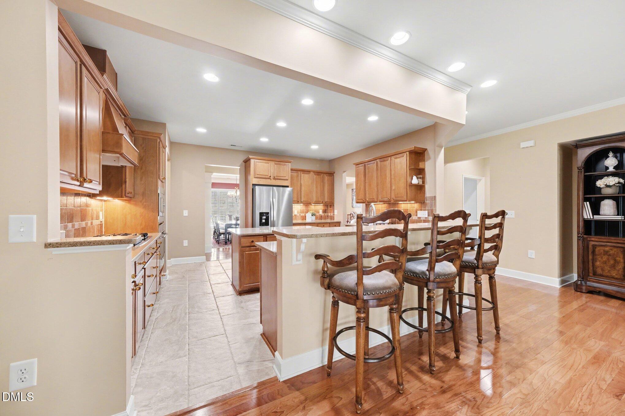 281 Beckingham Loop Cary, NC 27519 - Photo 16 of 56 a dining room with furniture a window and stainless steel appliances